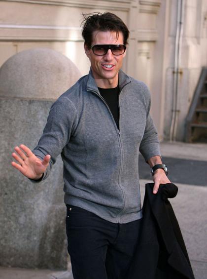 Tom Cruise pointedly avoids looking at Scientology protestor