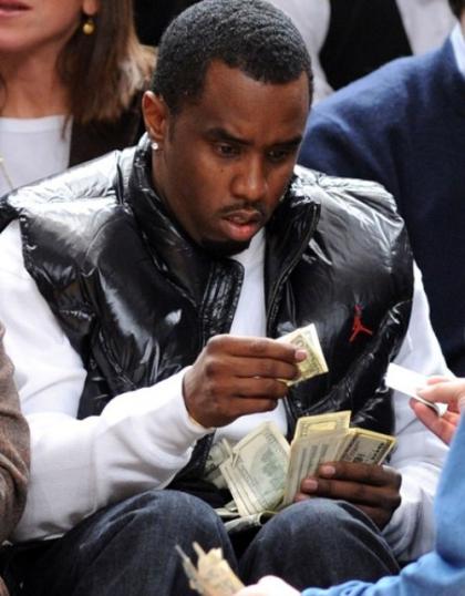 I wonder what Diddy is buying with that wad of cash?