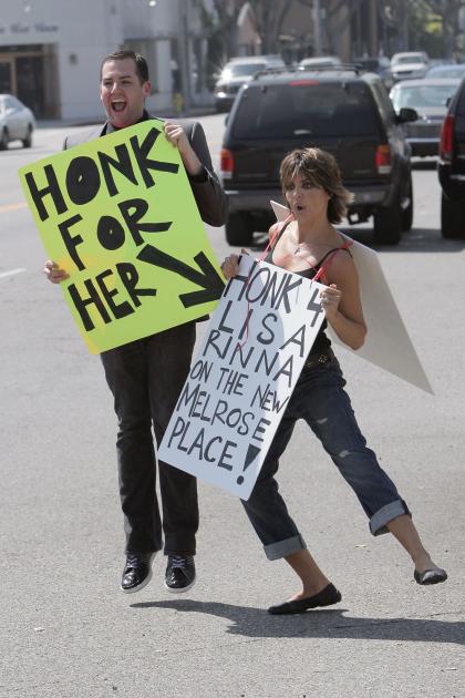 Lisa Rinna campaigns with a sandwich board to be on Melrose Place