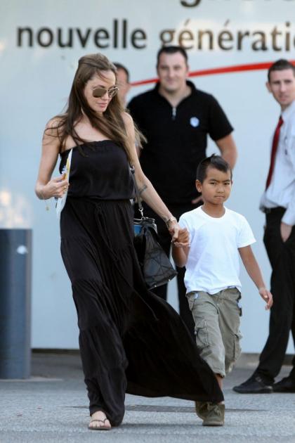 Goth Angelina Jolie takes Maddox (toy) gun shopping in France