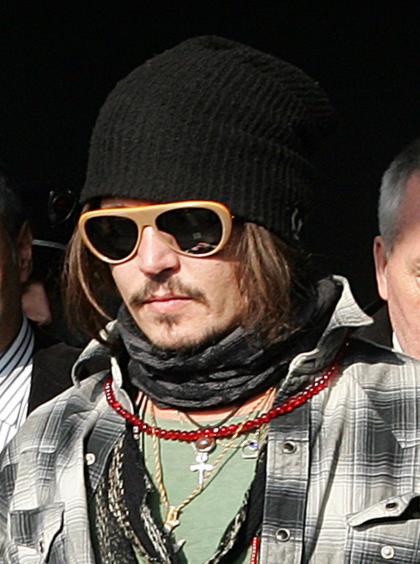 Johnny Depp looks amused while unveiling his lifesize statue in Serbia