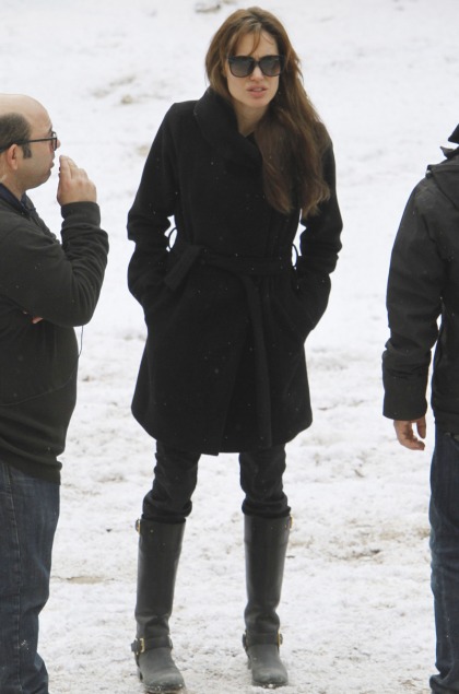 Angelina Jolie wears a great black coat, gets groped by Brad Pitt