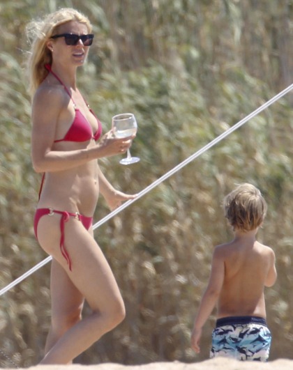 Dame Gwyneth deigns to wear a little red bikini: does Goop have bolt-ons?