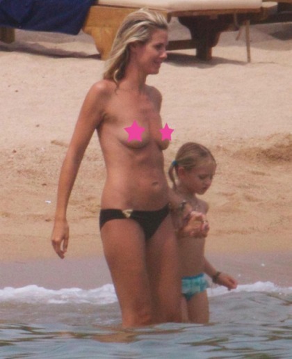 Heidi Klum Goes Topless in Sardinia