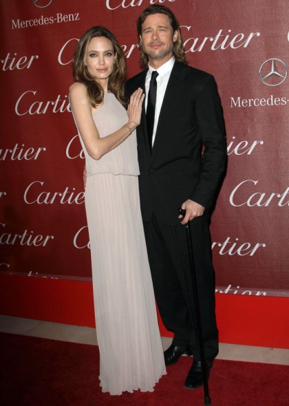 Angelina Jolie looks knocked up in a sack in Palm Springs, while Brad wins an award