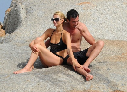 Paris Hilton thinks that if she cuddles a new guy while in a monokini we?ll pay attention