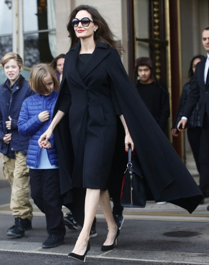 Angelina Jolie wore a caped coat to visit the Louvre with all six kids