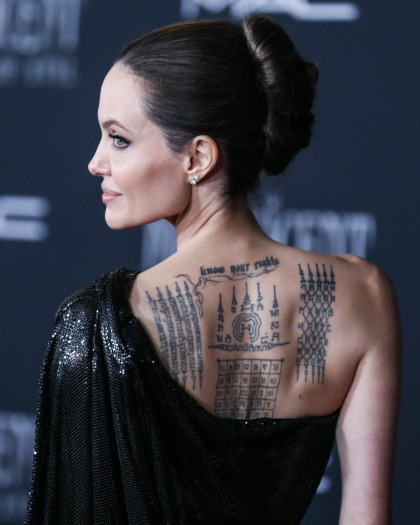 Angelina Jolie met a young British actor who has her face tattooed on his arm